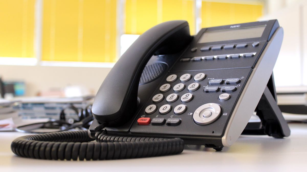 Business desk phone in modern office for VoIP phone system comparison