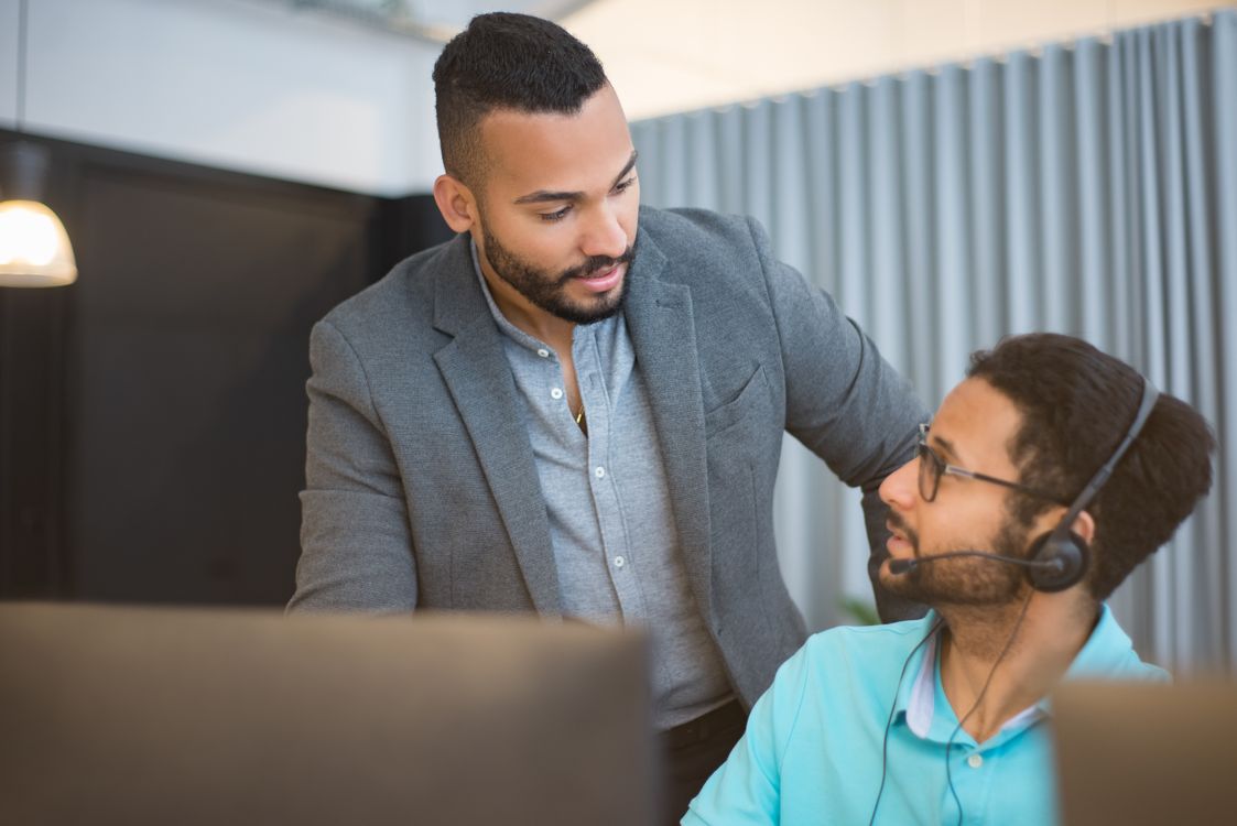 Business professionals reviewing IT provider performance in office meeting